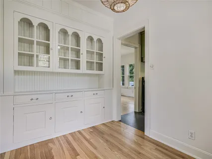 a view of a closet with wooden floor