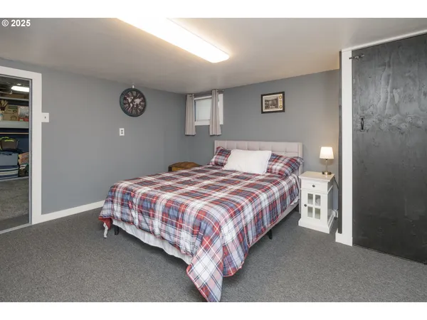 a bedroom with a bed and a lamp