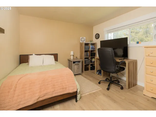 a bedroom with a bed and a desk