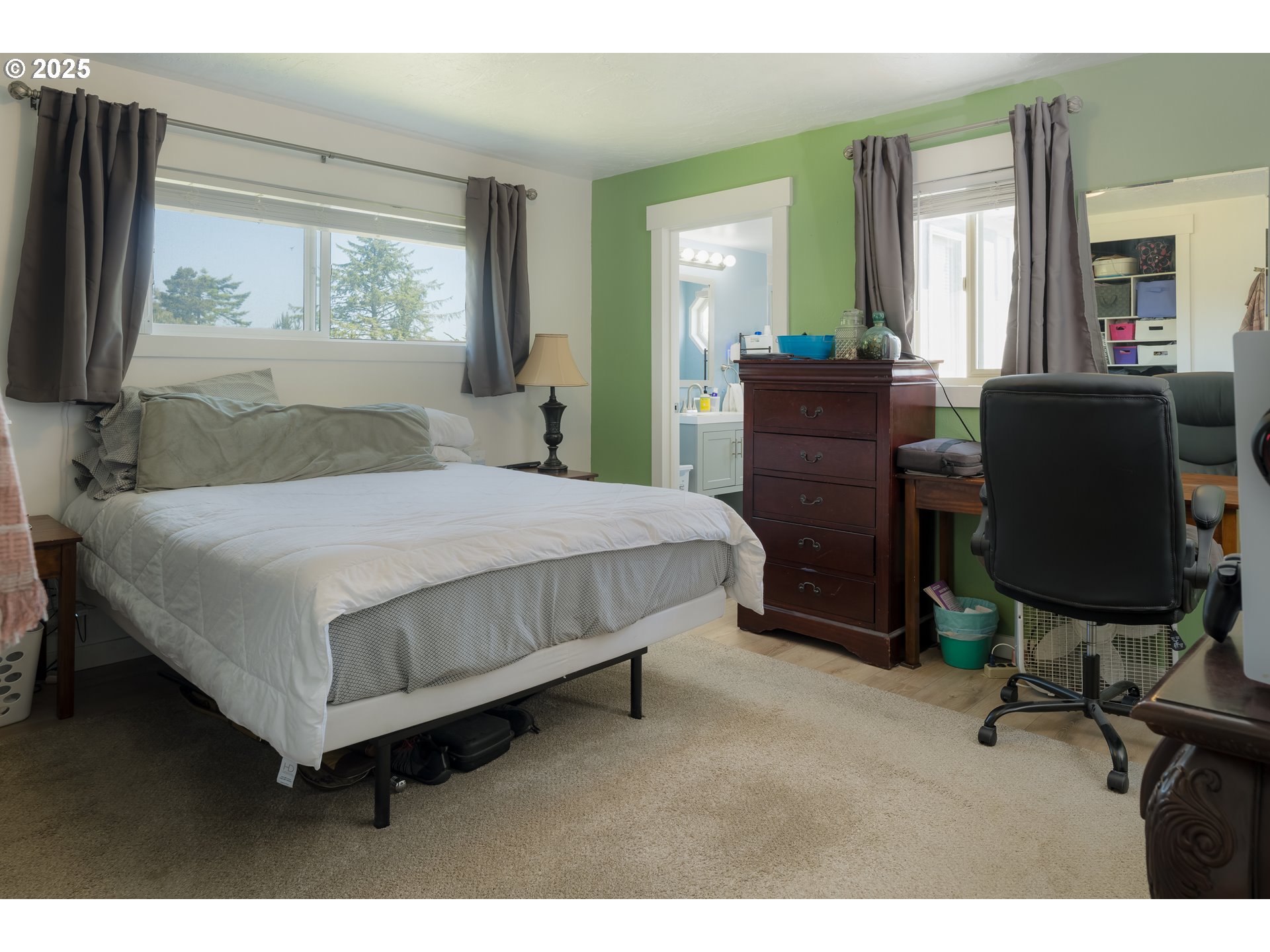 90431 Lewis Road Warrenton, OR 97146 - Photo 8 of 26 a bedroom with a bed and large windows