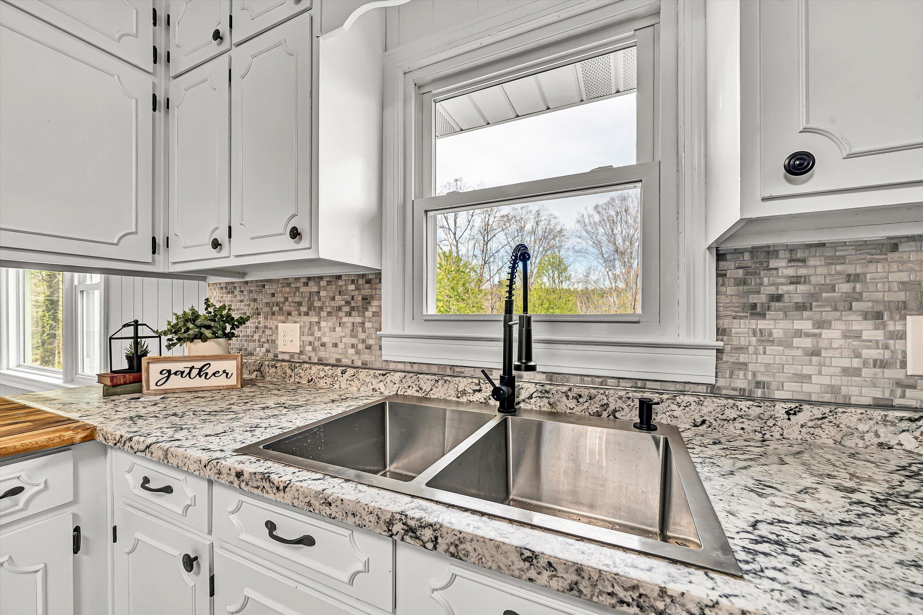 731 Bassett Heights Road Bassett, VA 24055 - Photo 11 of 45 a kitchen with granite countertop a sink window and cabinets