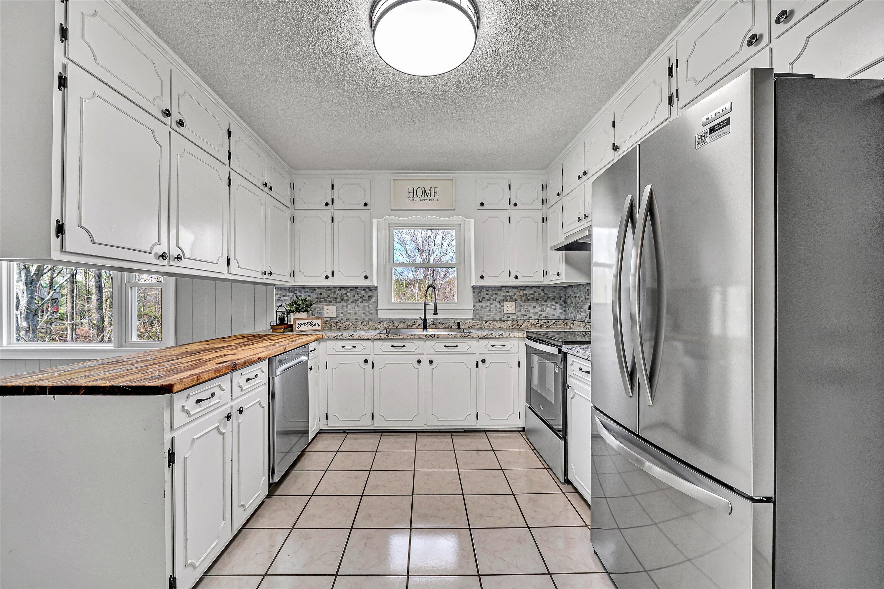 731 Bassett Heights Road Bassett, VA 24055 - Photo 14 of 45 a kitchen with stainless steel appliances granite countertop a refrigerator sink and cabinets