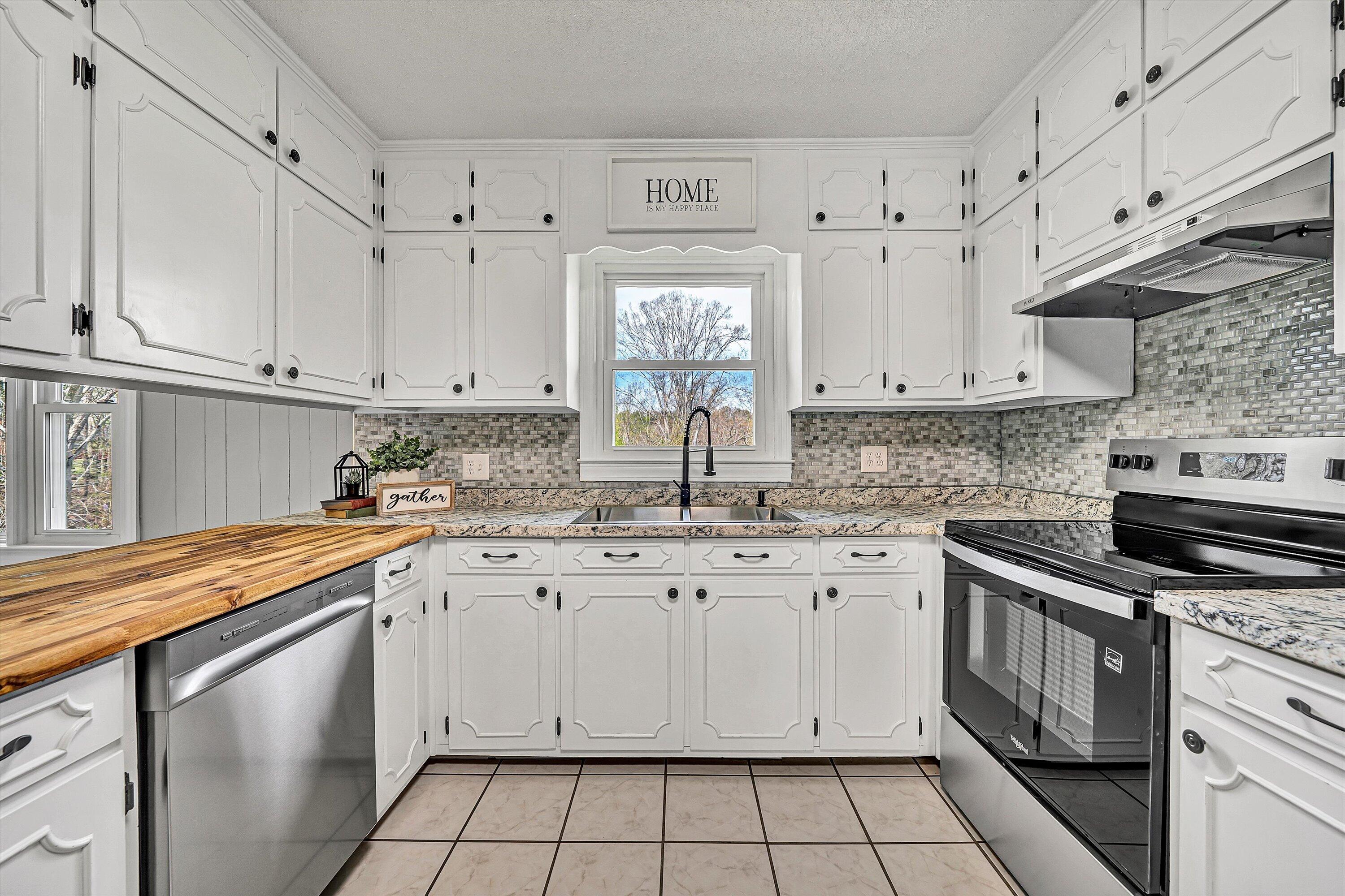 731 Bassett Heights Road Bassett, VA 24055 - Photo 16 of 45 a kitchen with granite countertop white cabinets and white appliances