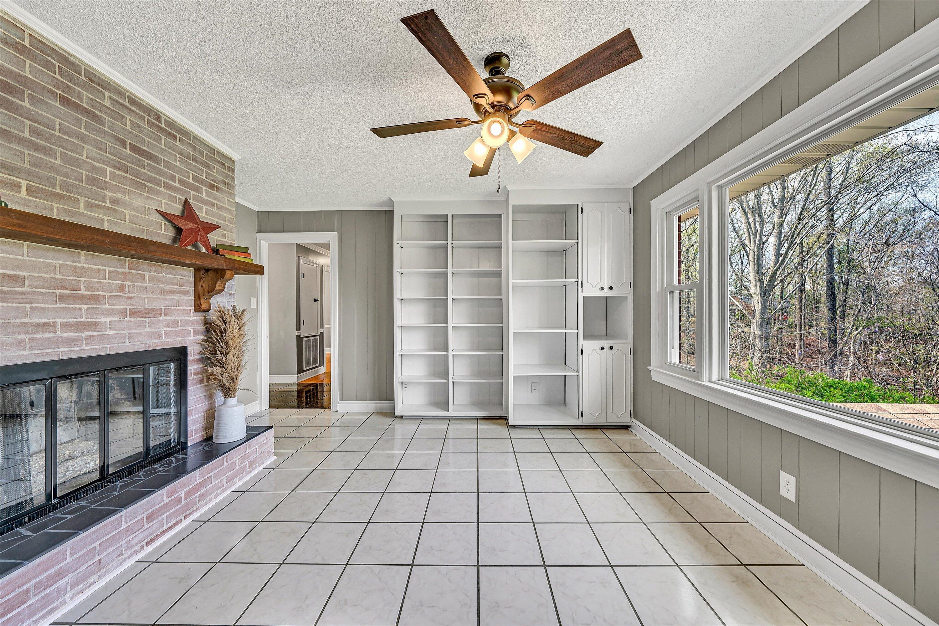 731 Bassett Heights Road Bassett, VA 24055 - Photo 17 of 45 a view of an empty room with a fireplace and windows