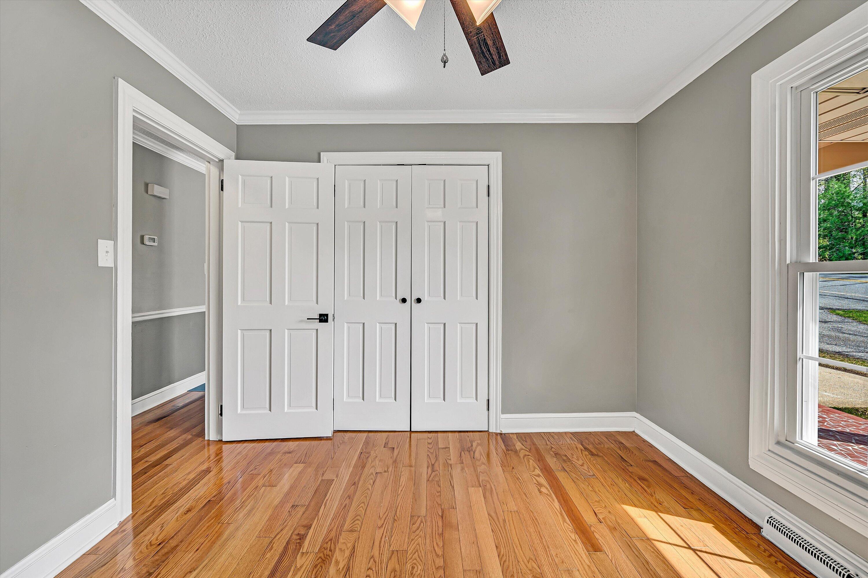 731 Bassett Heights Road Bassett, VA 24055 - Photo 23 of 45 a view of an empty room with window and wooden floor