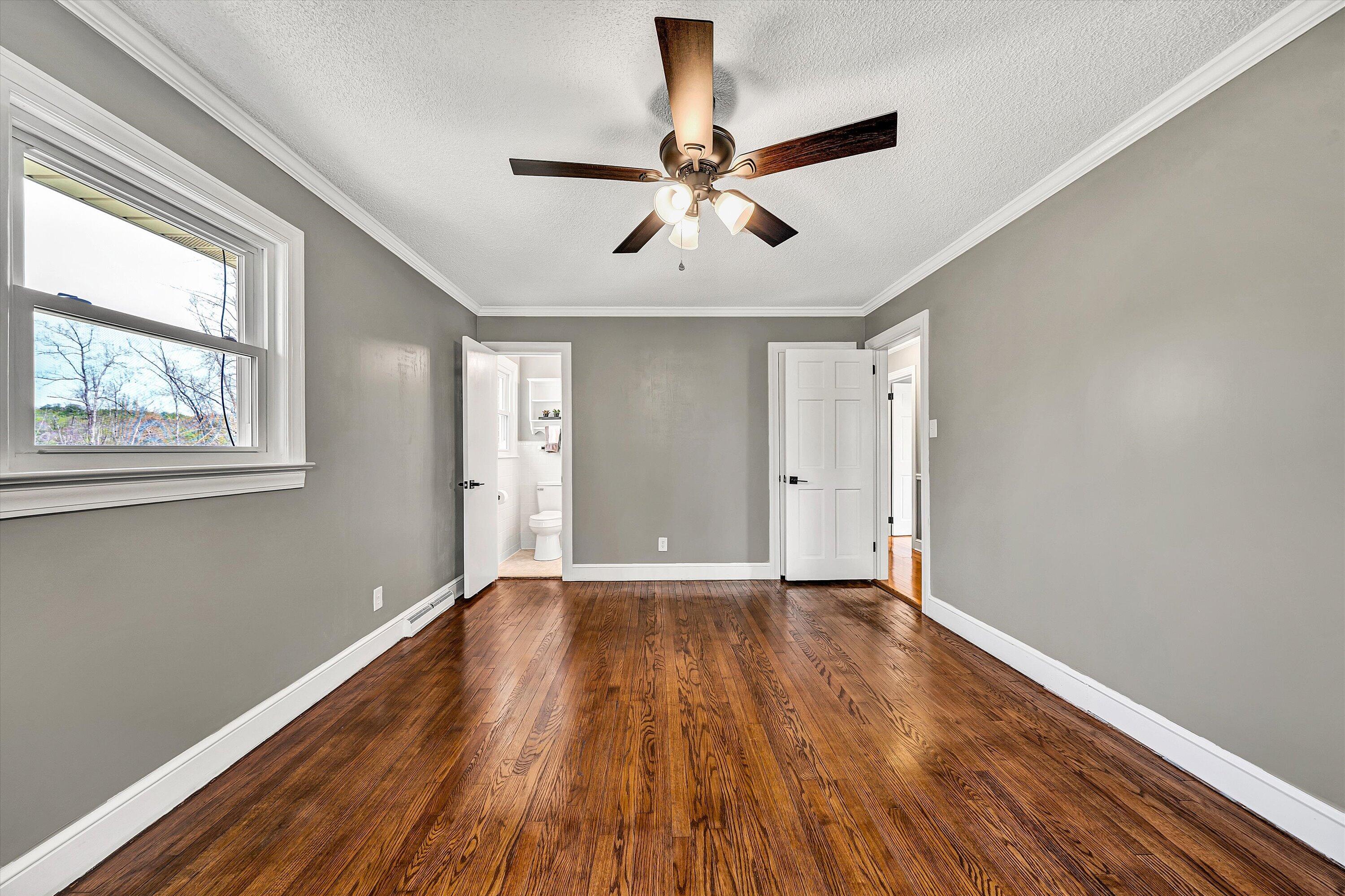 731 Bassett Heights Road Bassett, VA 24055 - Photo 24 of 45 a view of an empty room with wooden floor and a window