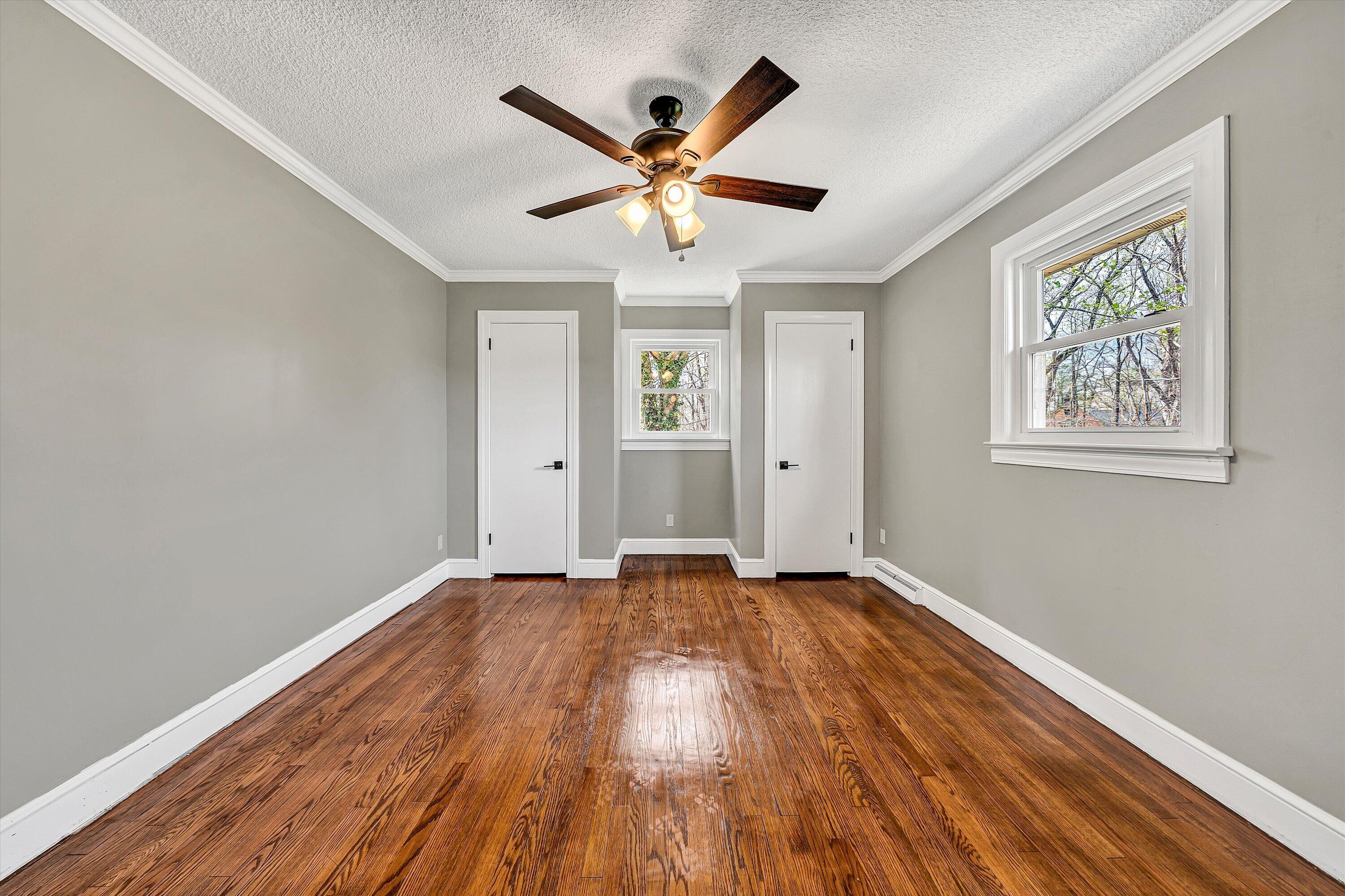 731 Bassett Heights Road Bassett, VA 24055 - Photo 25 of 45 an empty room with wooden floor and windows