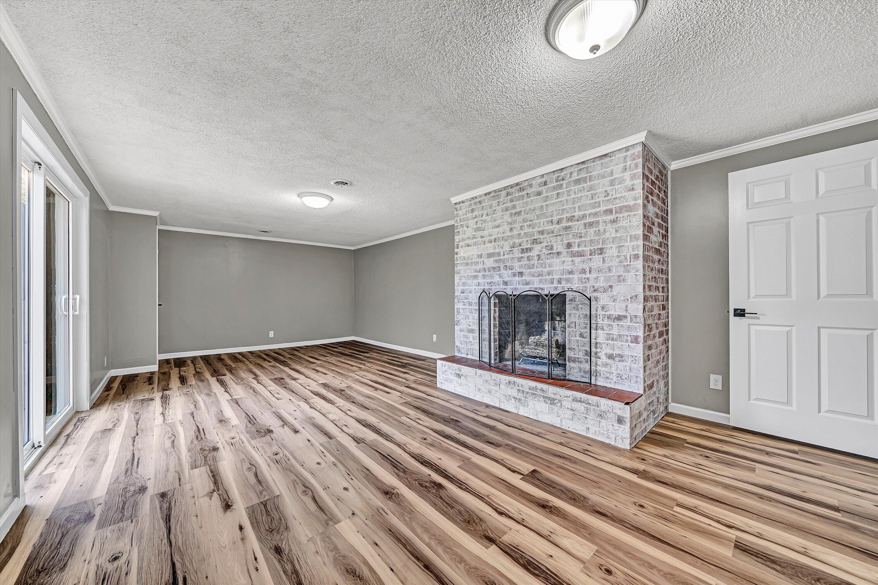 731 Bassett Heights Road Bassett, VA 24055 - Photo 26 of 45 a view of empty room with wooden floor and fireplace