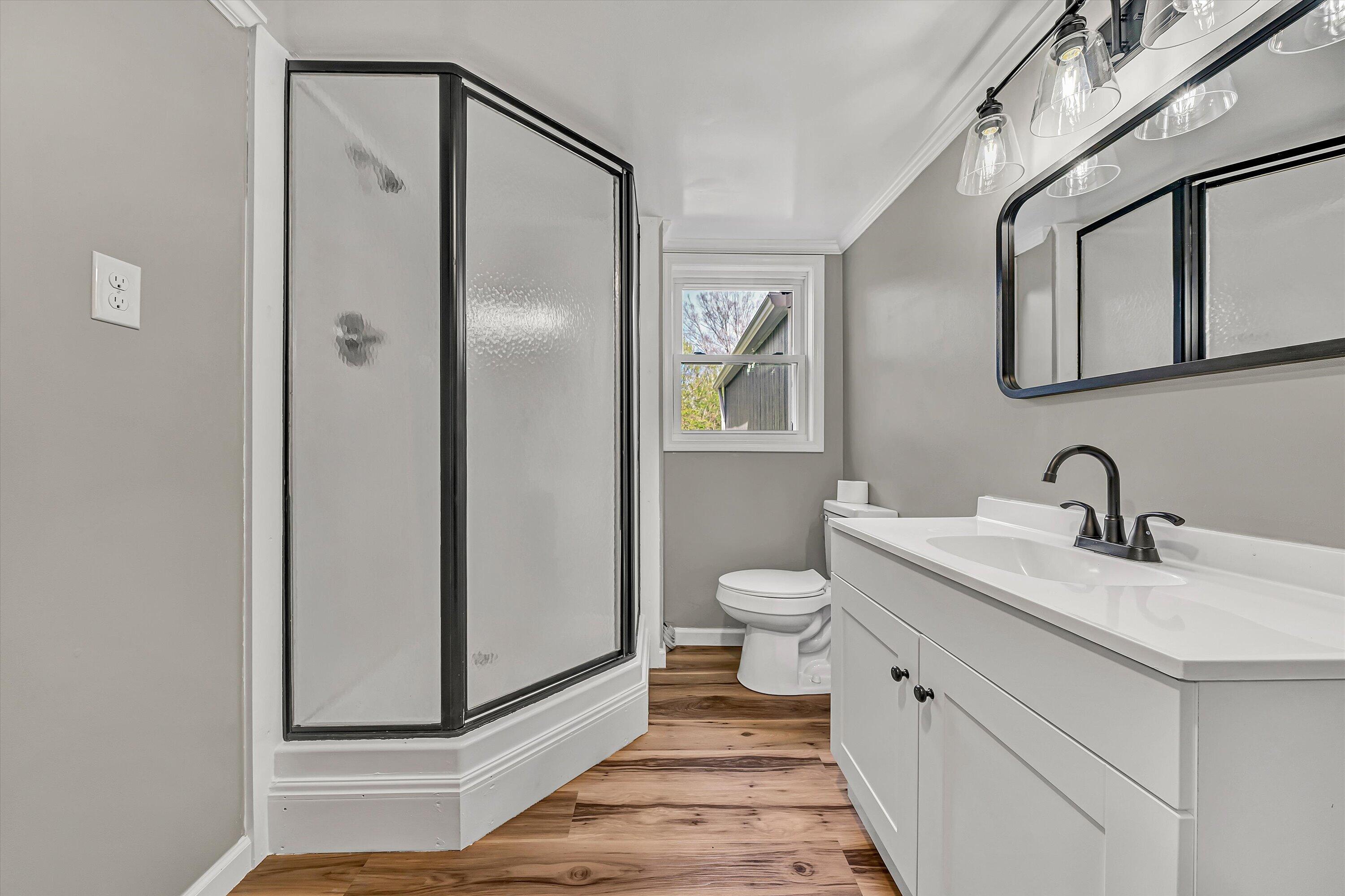 731 Bassett Heights Road Bassett, VA 24055 - Photo 28 of 45 a bathroom with a granite countertop sink mirror vanity and toilet