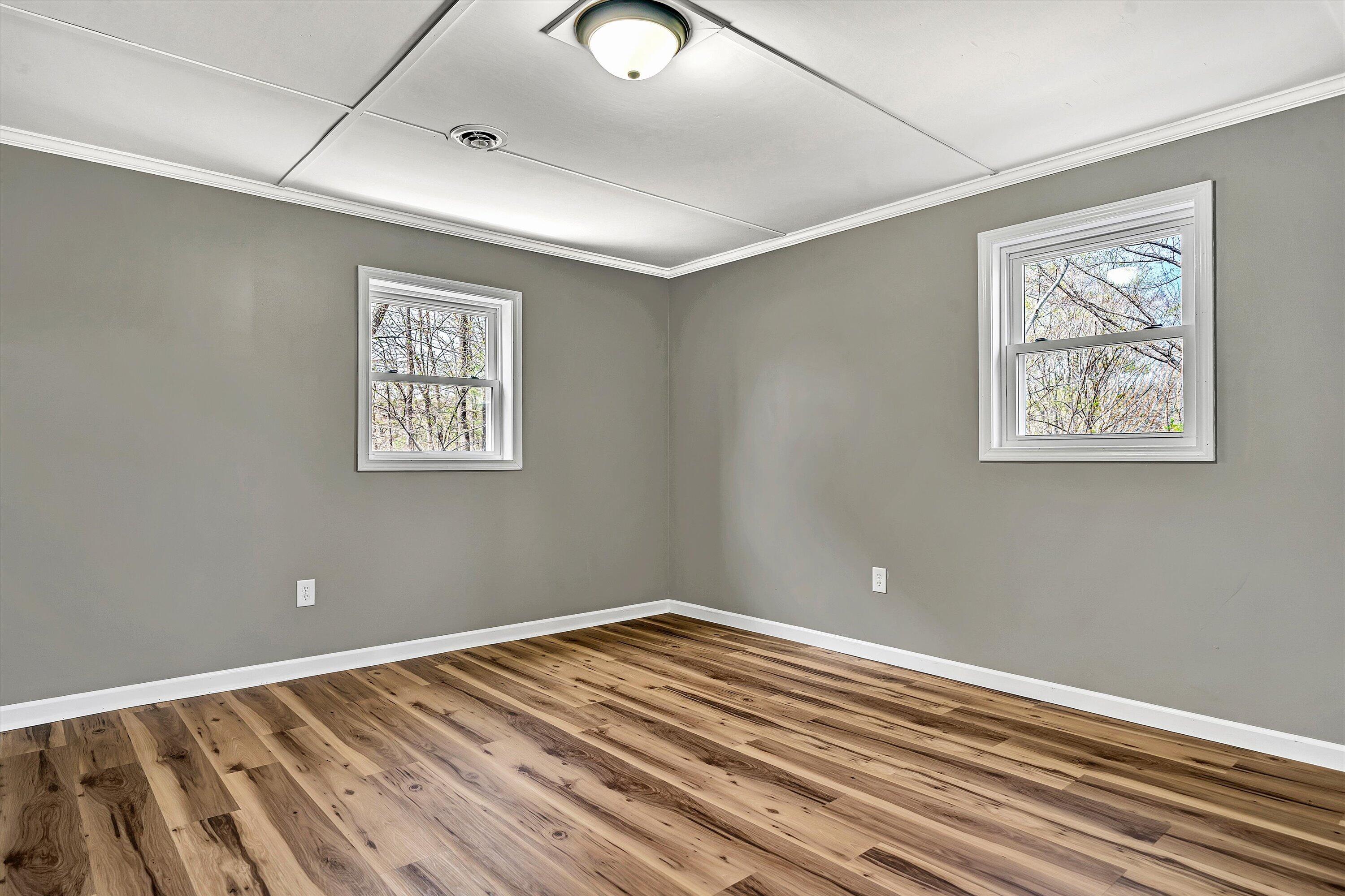 731 Bassett Heights Road Bassett, VA 24055 - Photo 30 of 45 a view of empty room with wooden floor