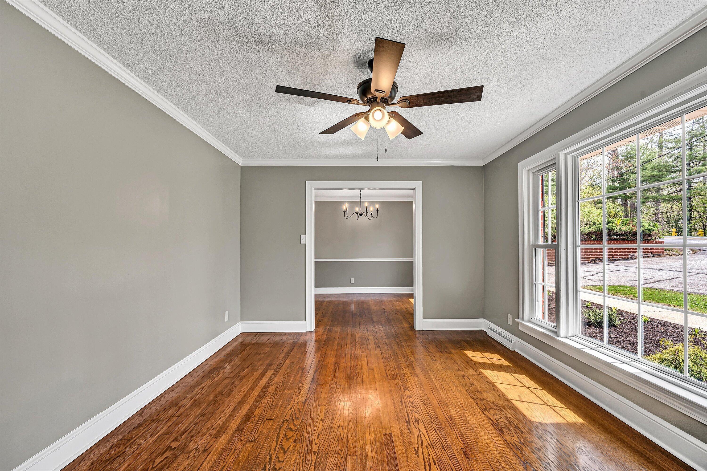 731 Bassett Heights Road Bassett, VA 24055 - Photo 6 of 45 a view of empty room with wooden floor and fan