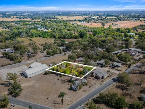 an aerial view of a house with a yard