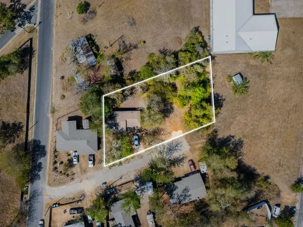 an aerial view of a house a yard and mountain view