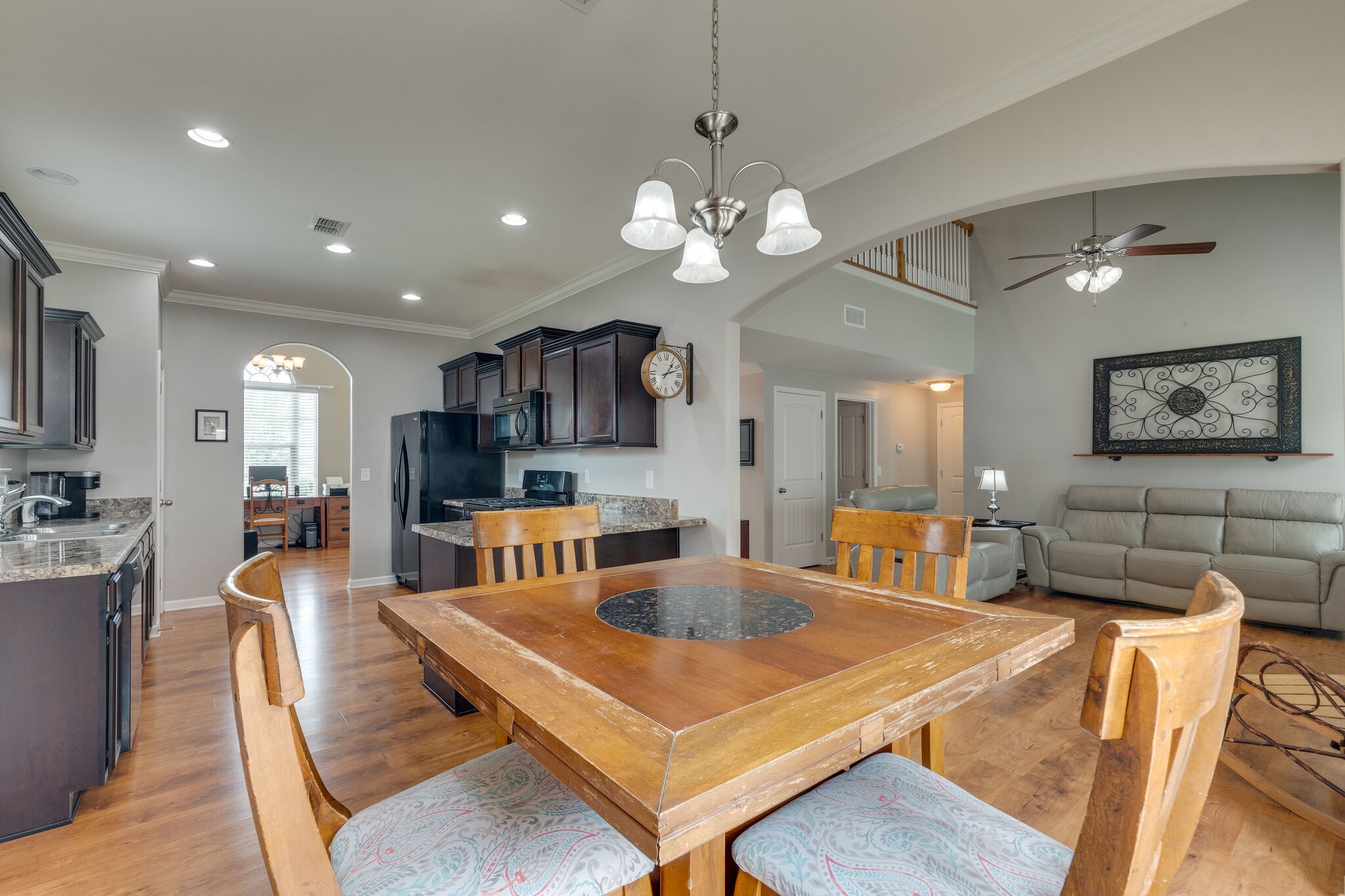 2018 Lincoln Road Spring Hill, TN 37174 - Photo 15 of 32 a living room with stainless steel appliances kitchen island granite countertop furniture a rug kitchen view and a chandelier