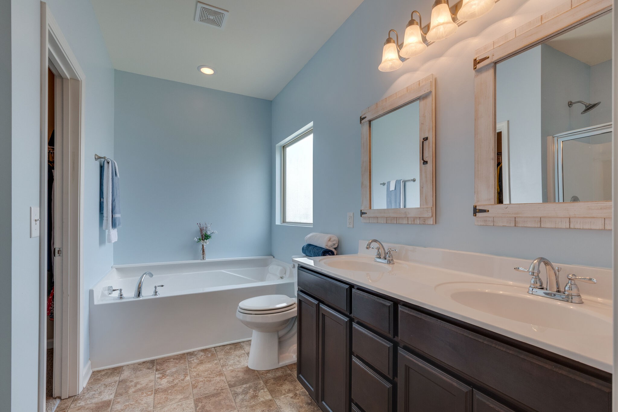2018 Lincoln Road Spring Hill, TN 37174 - Photo 21 of 32 a bathroom with a double vanity sink toilet mirror and bathtub