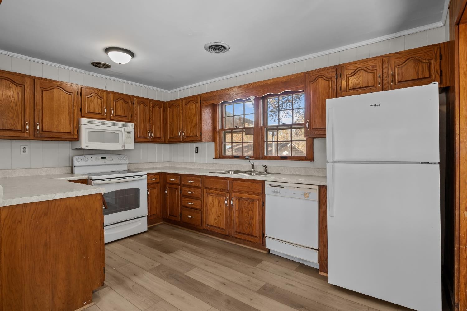 1260 Clydeton Road Waverly, TN 37185 - Photo 11 of 41 a kitchen with refrigerator cabinets and wooden floor