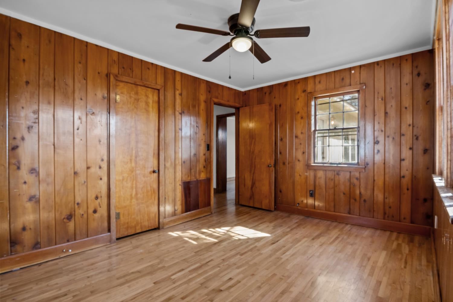 1260 Clydeton Road Waverly, TN 37185 - Photo 20 of 41 an empty room with wooden floor ceiling fan and windows