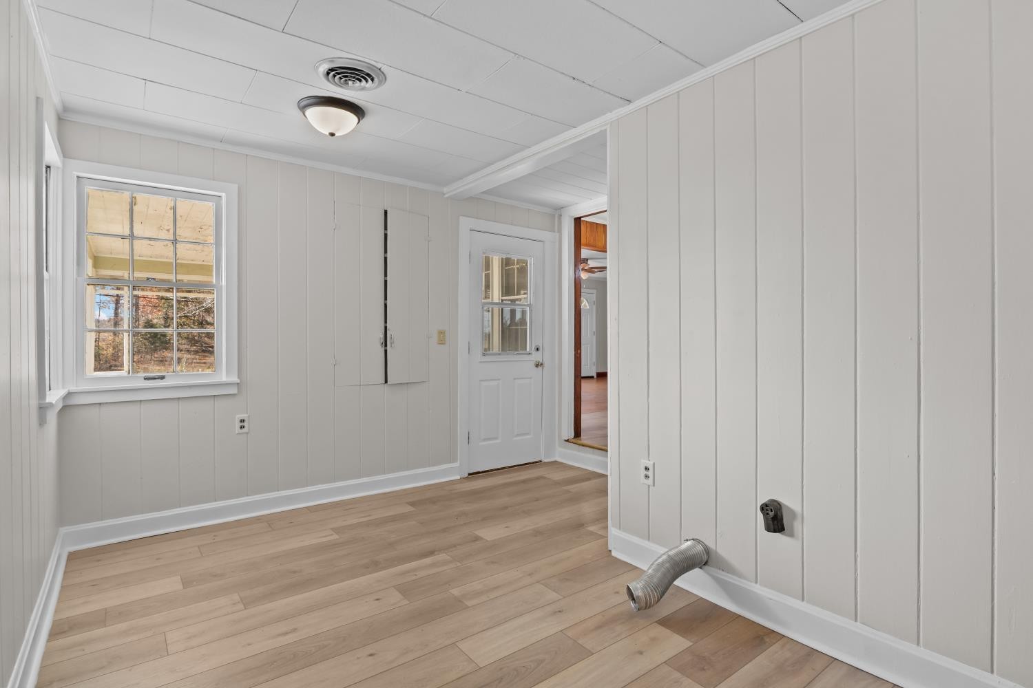 1260 Clydeton Road Waverly, TN 37185 - Photo 26 of 41 a view of an empty room with wooden floor and a window