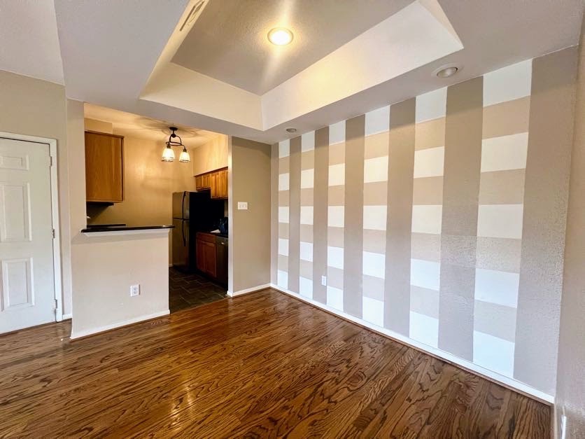 4041 Drake Street, Unit 118 Houston, TX 77005 - Photo 10 of 22 a view of empty room with wooden floor and a window
