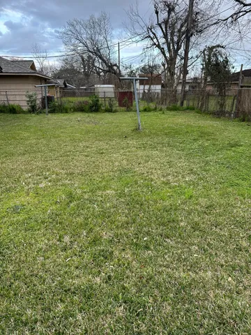 a view of a backyard with large trees