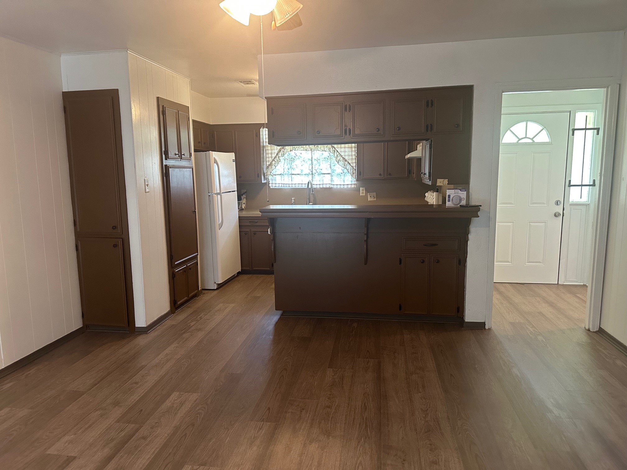 6003 Heatherbrook Drive Houston, TX 77085 - Photo 4 of 13 a kitchen with stainless steel appliances wooden floors and wooden cabinets