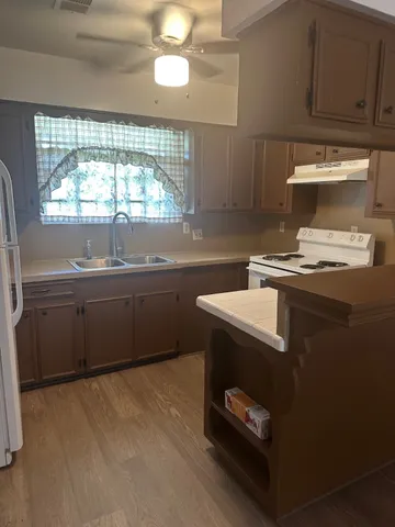 a kitchen that has a sink and a stove