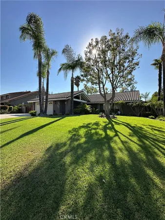 a view of a house with pool and a yard