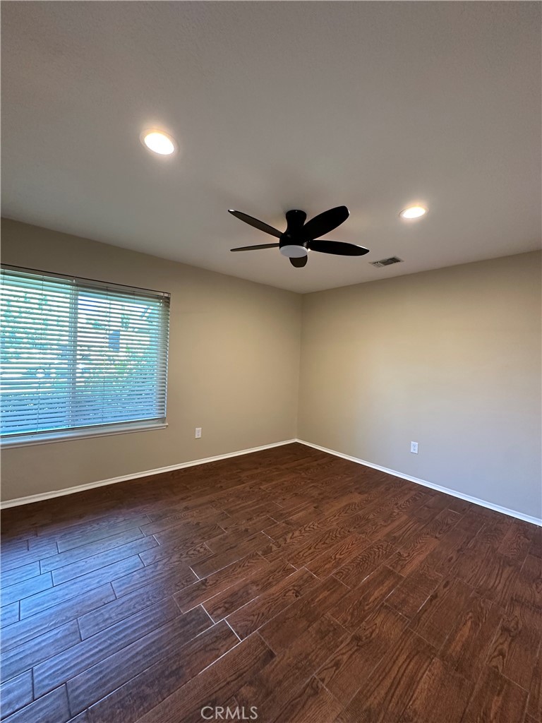 6707 Rycroft Drive Riverside, CA 92506 - Photo 22 of 41 a view of an empty room with wooden floor and a window