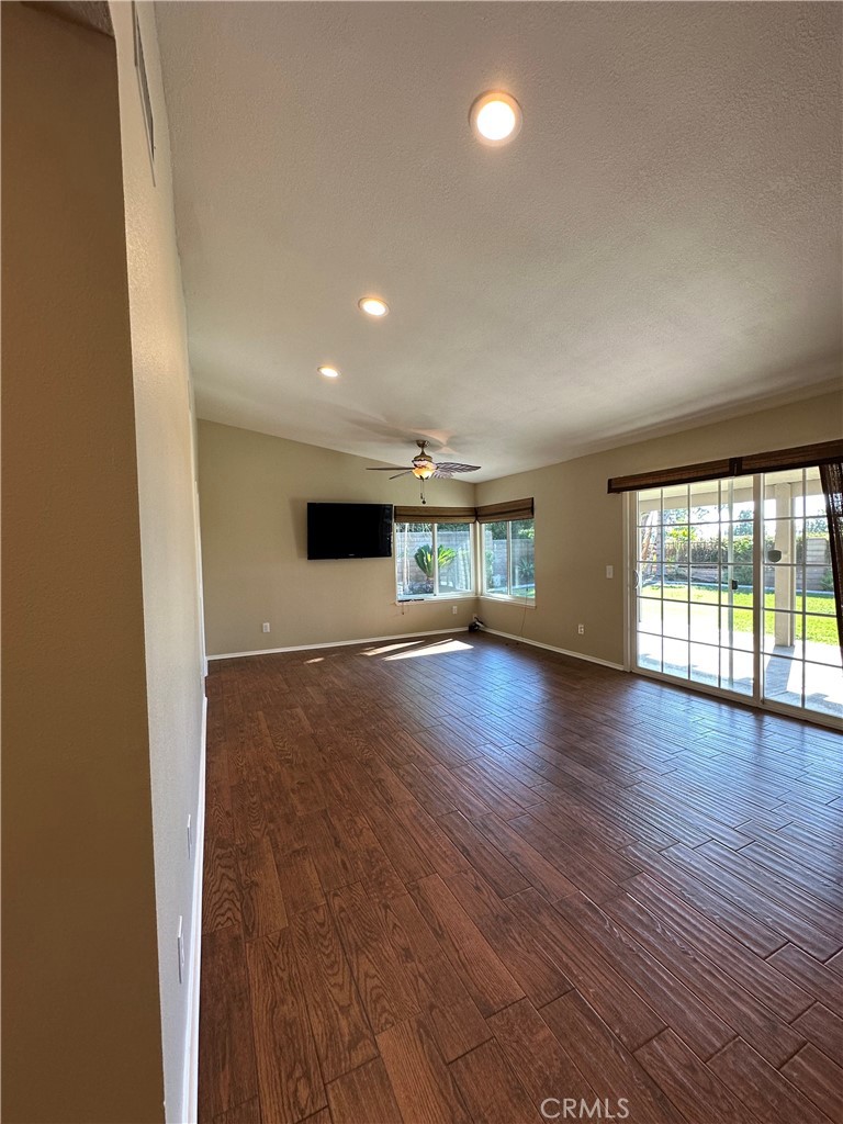 6707 Rycroft Drive Riverside, CA 92506 - Photo 4 of 41 an empty room with wooden floor and windows