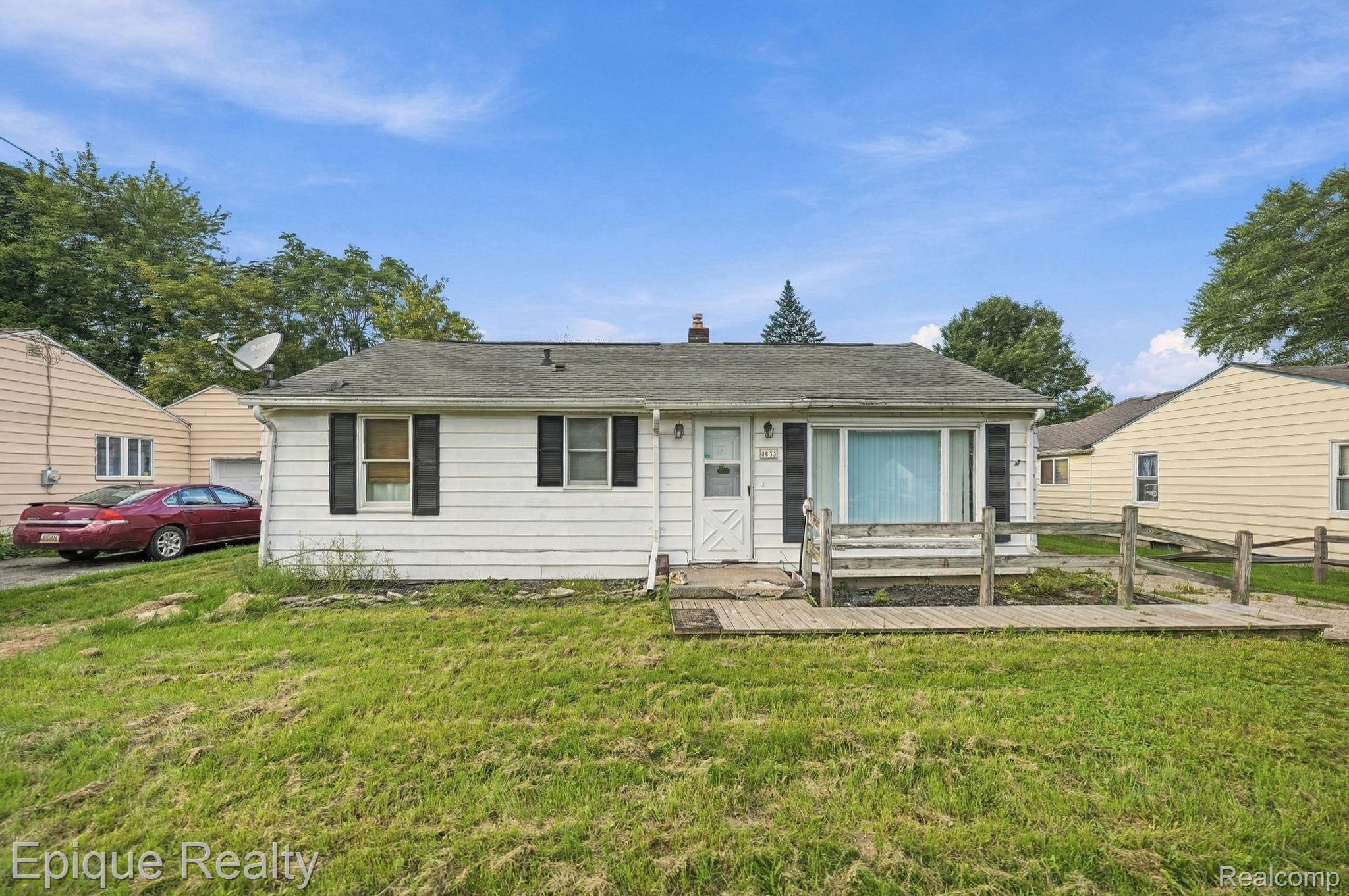 4033 Risedorph Street Burton, MI 48509 - Photo 1 of 25 White siding exterior with a dark shingle roof