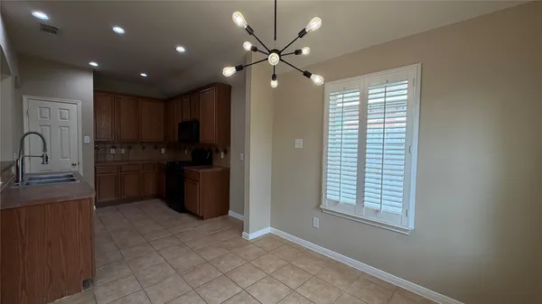 a kitchen with stainless steel appliances a refrigerator sink and stove