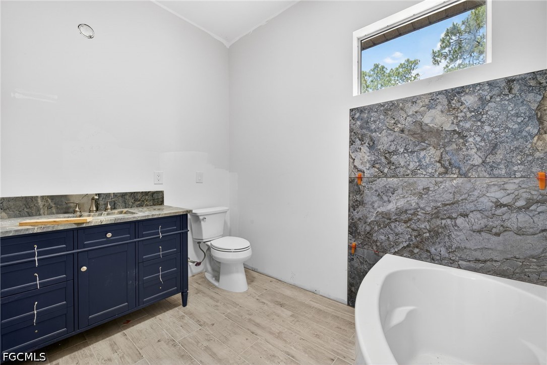 2665 Oil Well Road Naples, FL 34120 - Photo 31 of 40 a bathroom with a toilet sink and mirror