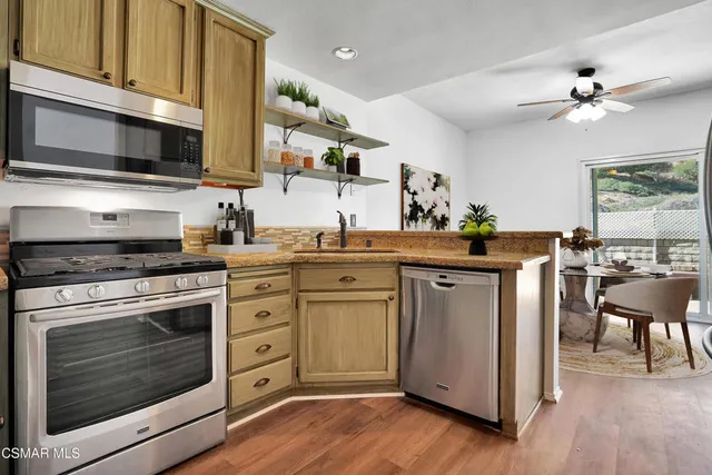 a kitchen with stainless steel appliances a stove microwave and cabinets