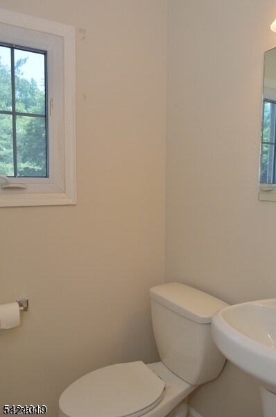 89 Forsythia Lane, Unit A Paramus, NJ 07652 - Photo 11 of 12 a white toilet sitting next to a window