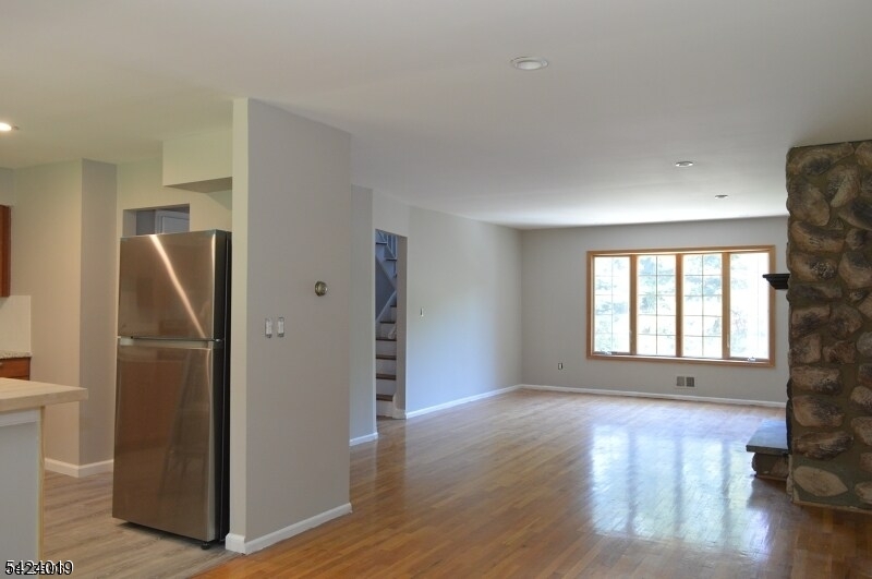 89 Forsythia Lane, Unit A Paramus, NJ 07652 - Photo 5 of 12 a view of kitchen with furniture and refrigerator