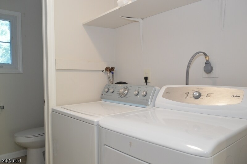 89 Forsythia Lane, Unit A Paramus, NJ 07652 - Photo 8 of 12 a utility room with dryer and washer