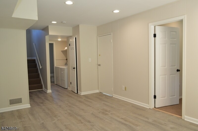 89 Forsythia Lane, Unit A Paramus, NJ 07652 - Photo 9 of 12 an empty room with closet and wooden door