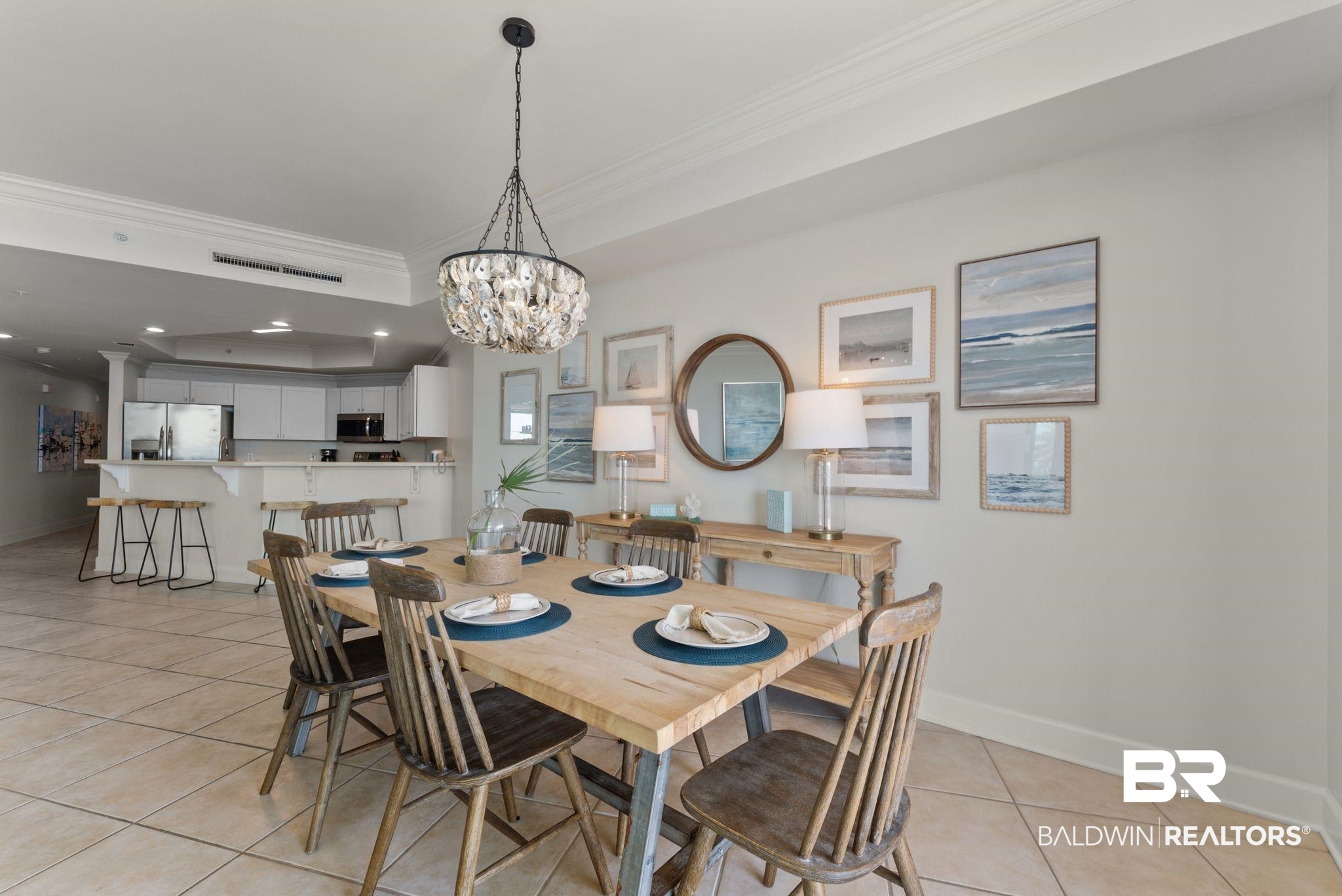 27580 Canal Road, Unit 1233 Orange Beach, AL 36561 - Photo 38 of 79 Dining space featuring ornamental molding, a raised ceiling, light tile patterned floors, and hanging lights