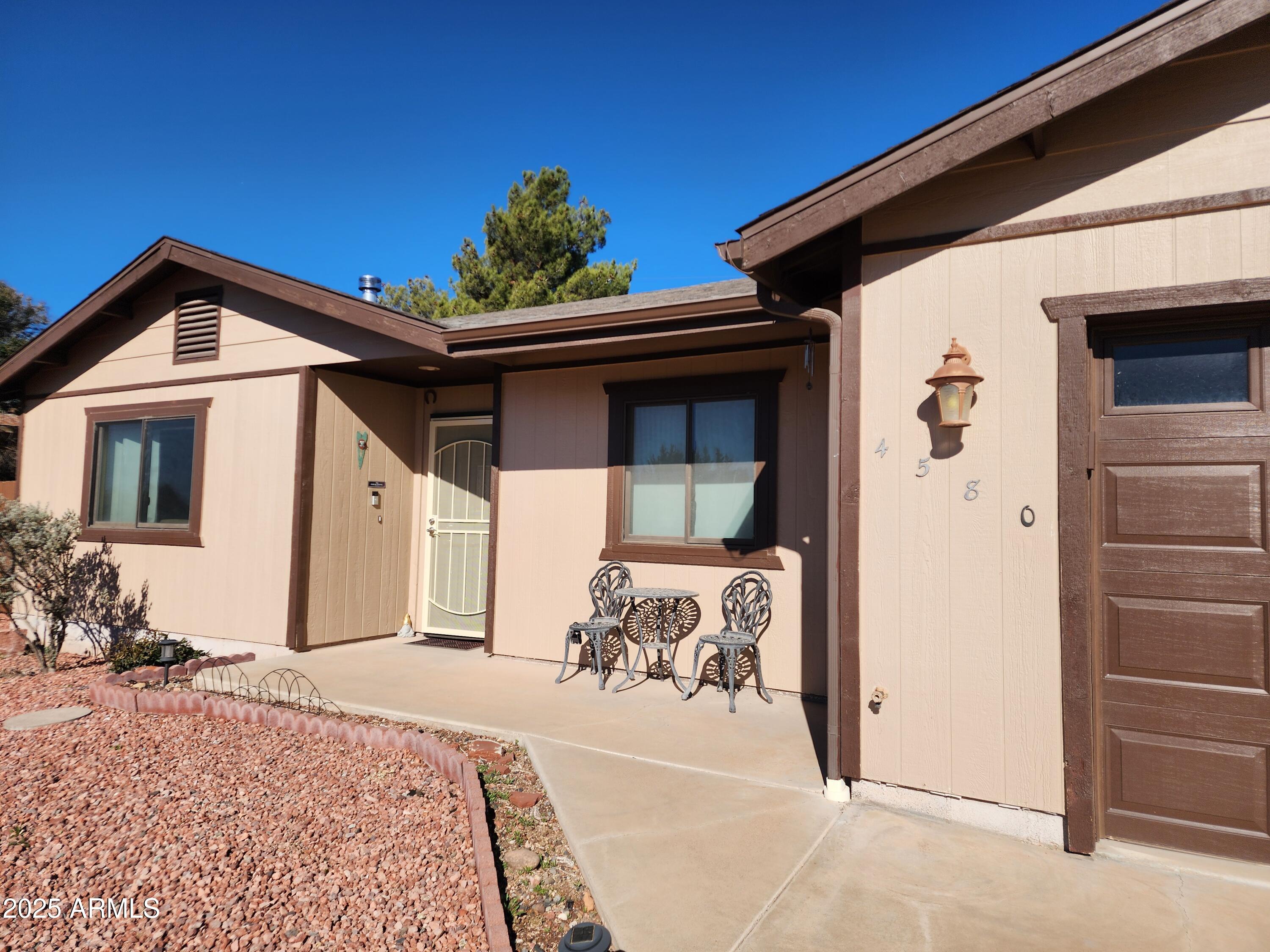 4580 East Steven Way Rimrock, AZ 86335 - Photo 1 of 17 a front view of a house with a potted plant
