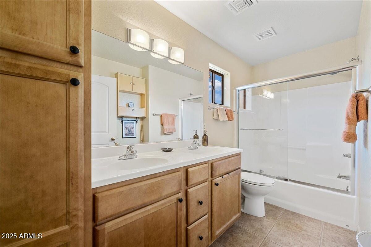4580 East Steven Way Rimrock, AZ 86335 - Photo 13 of 17 a bathroom with a double vanity sink toilet mirror and shower