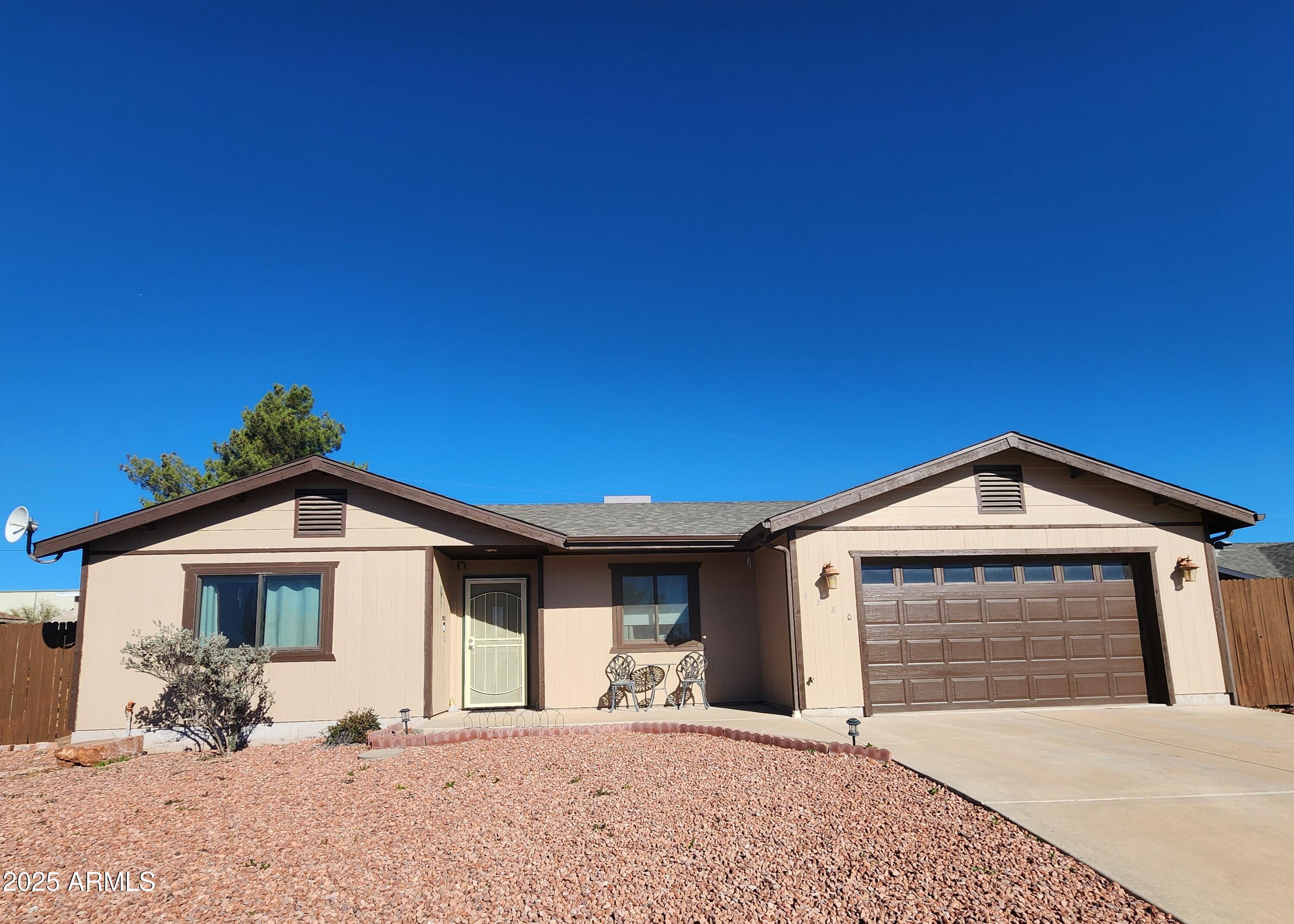 4580 East Steven Way Rimrock, AZ 86335 - Photo 2 of 17 a front view of a house with a yard and garage