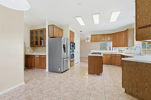 a kitchen with stainless steel appliances cabinets and a refrigerator