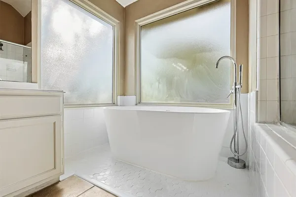 a bathroom with a glass shower door