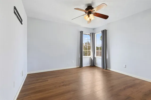 wooden floor in an empty room with a window