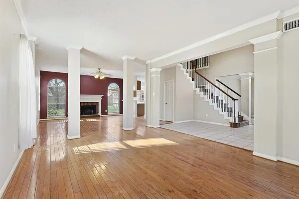 a view of a hallway with wooden floor and dining room