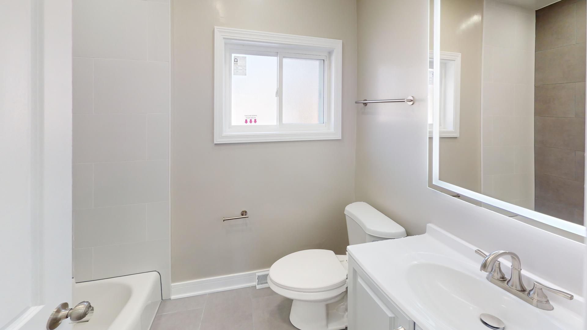 1321 Pitner Avenue, Unit A Evanston, IL 60201 - Photo 23 of 35 a bathroom with a toilet sink and mirror