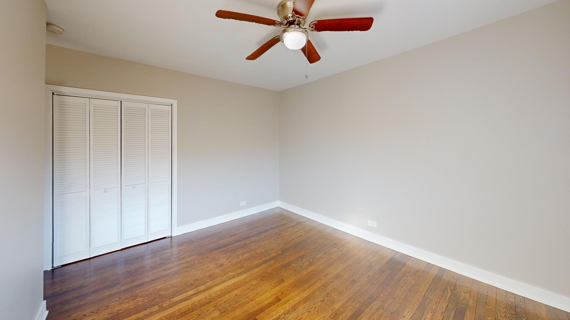1321 Pitner Avenue, Unit A Evanston, IL 60201 - Photo 27 of 35 an empty room with wooden floor closet and fan