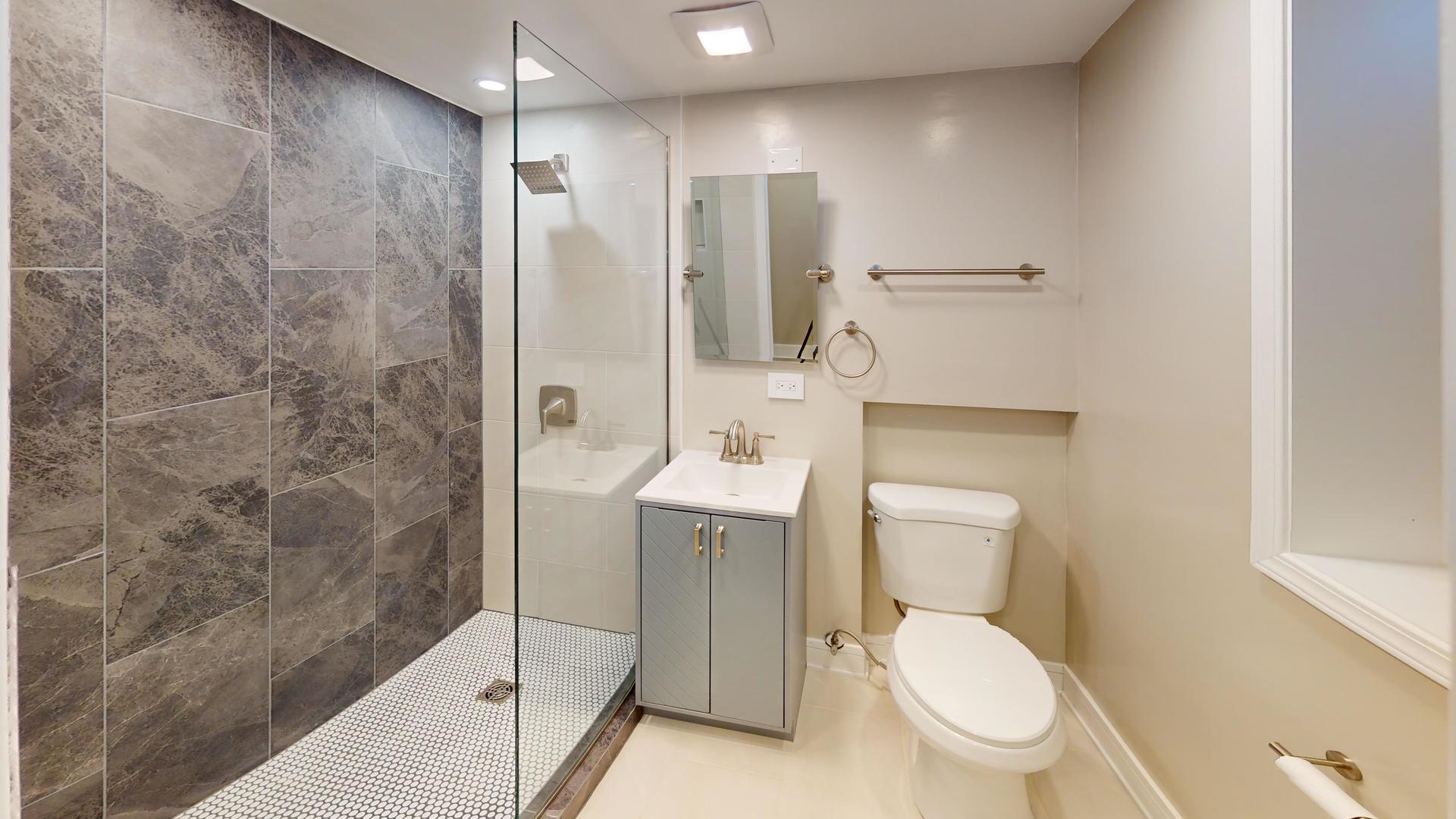 1321 Pitner Avenue, Unit A Evanston, IL 60201 - Photo 35 of 35 a bathroom with a toilet a sink and shower