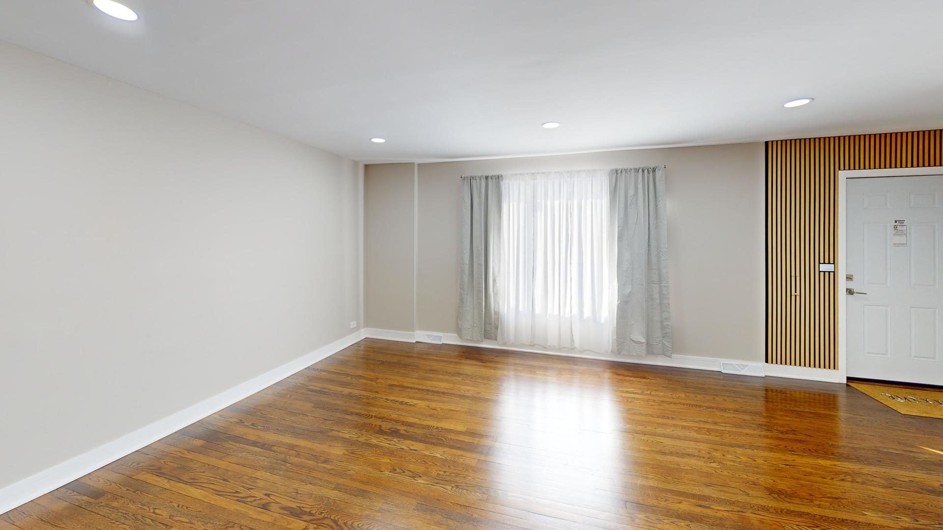 1321 Pitner Avenue, Unit A Evanston, IL 60201 - Photo 5 of 35 a view of wooden floor and windows in a room