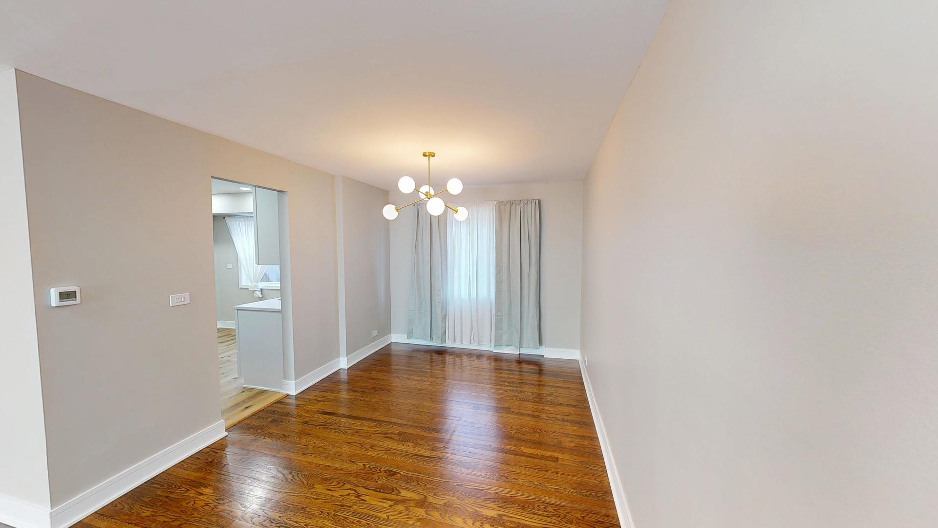 1321 Pitner Avenue, Unit A Evanston, IL 60201 - Photo 6 of 35 a view of a hallway with wooden floor and a bathroom